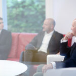 Business advisor and sitting together after securing a successful business sale agreement